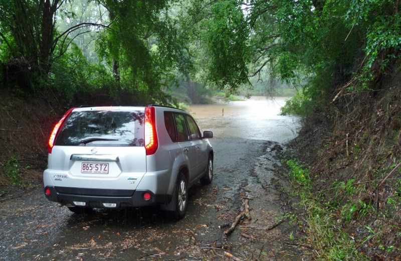 Tim reviewing a rather flooded causeway near their house
