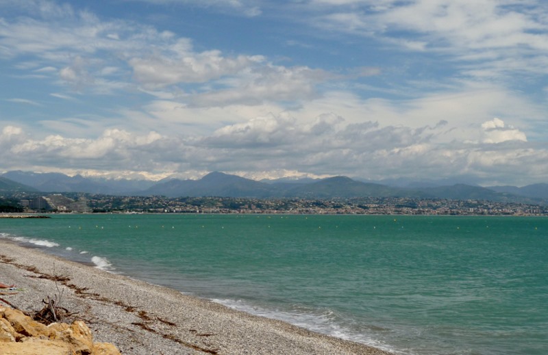 The snow capped mountains behind Nice