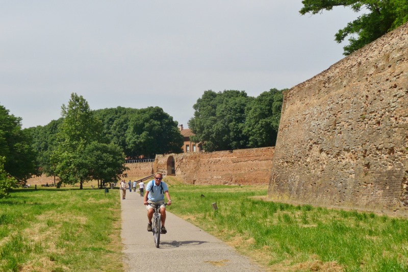 Rodney cycling outside the city walls