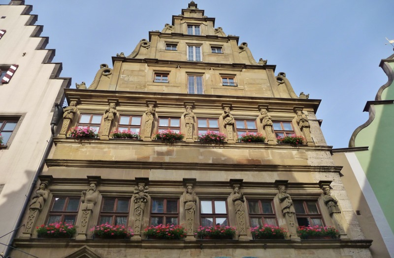 Baumeisterhaus with the Seven Virtues and Seven Vices. Gluttony is second from left on the lower level....