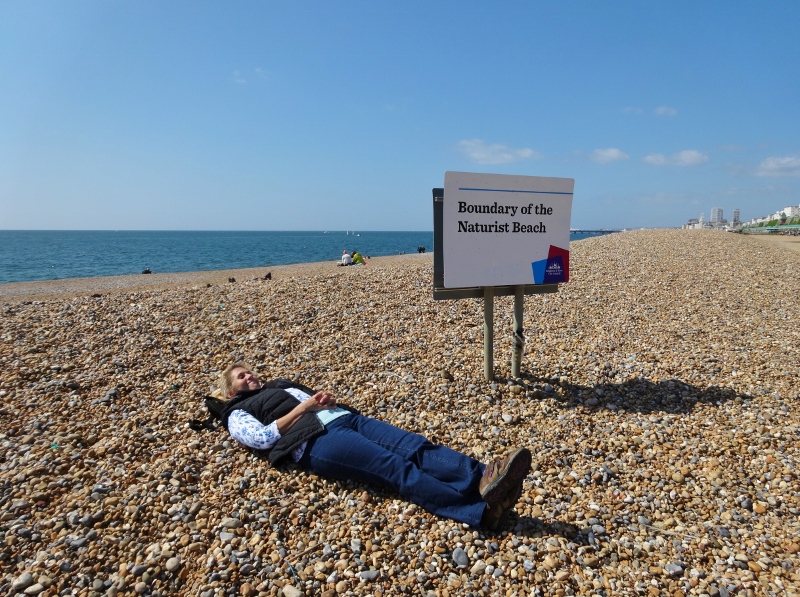 Relaxing nervously on the nudist beach at Brighton