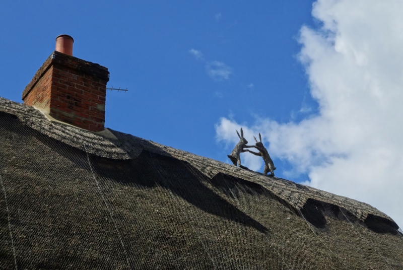 Thatched hares dancing on a thatched roof in Chishill, Essex