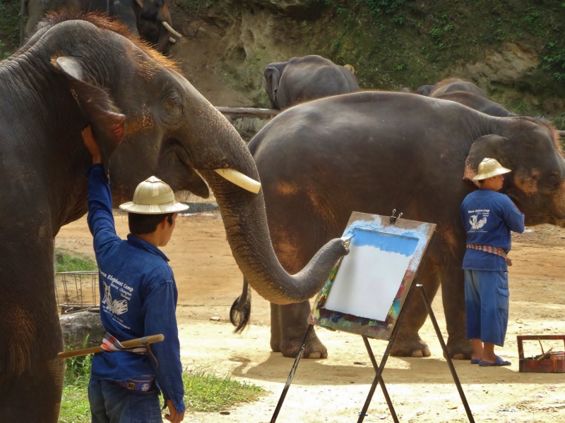 Elephants delicately painting the scenery