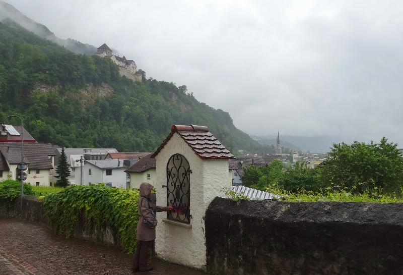 Vaduz castle from Mitteldorf and Laura is deadheading some flowers ......