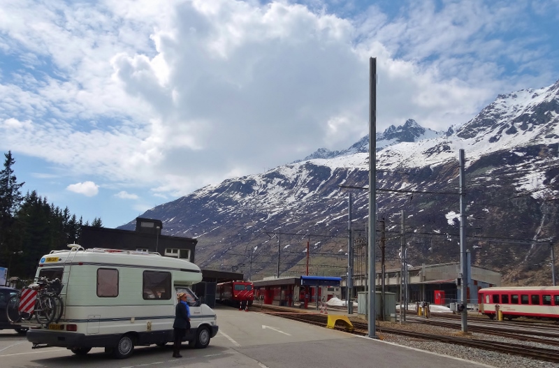 Eileen envying the number of wheels on the trains at the Andermatt Barnhof in Switzerland 